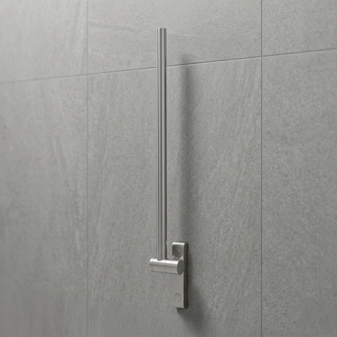 Metal fold up grab support bar mounted on a gray tiled wall in a bathroom