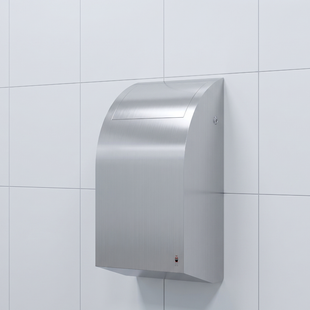 Stainless steel waste bin mounted on white tiled wall