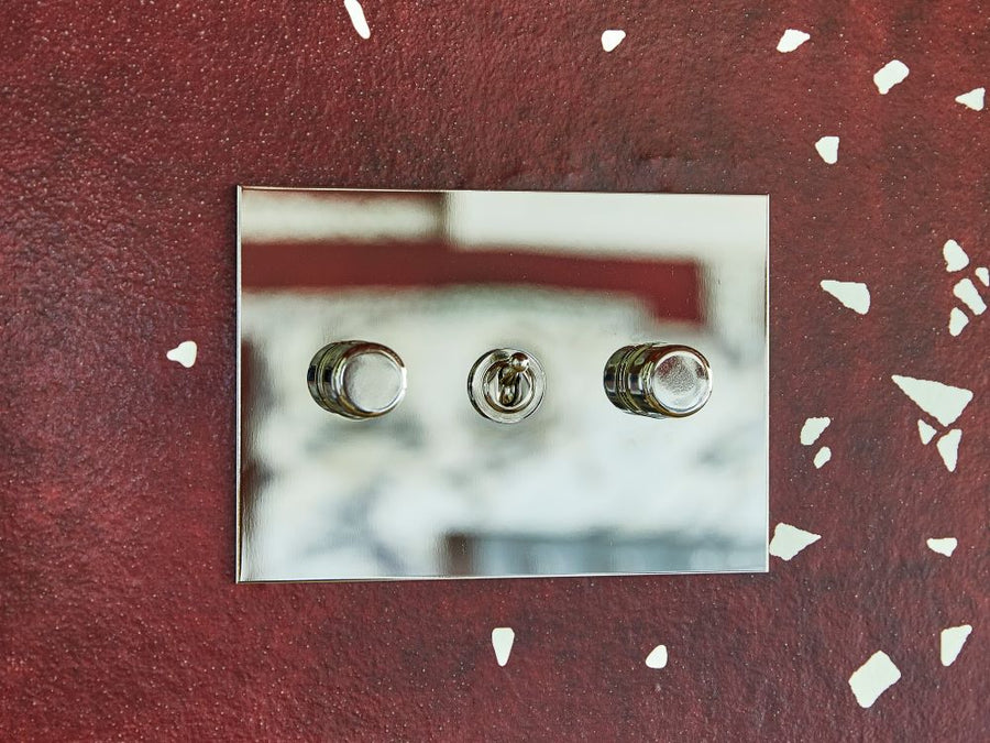 Forbes & Lomax invisible switch plate against a plastered wall