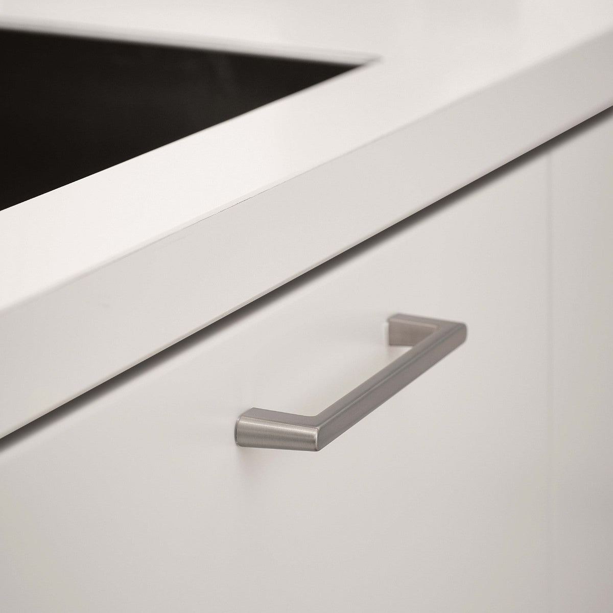 Inox look Furnipart Diner cabinet handle, 160 mm, on a white drawer under a white countertop.
