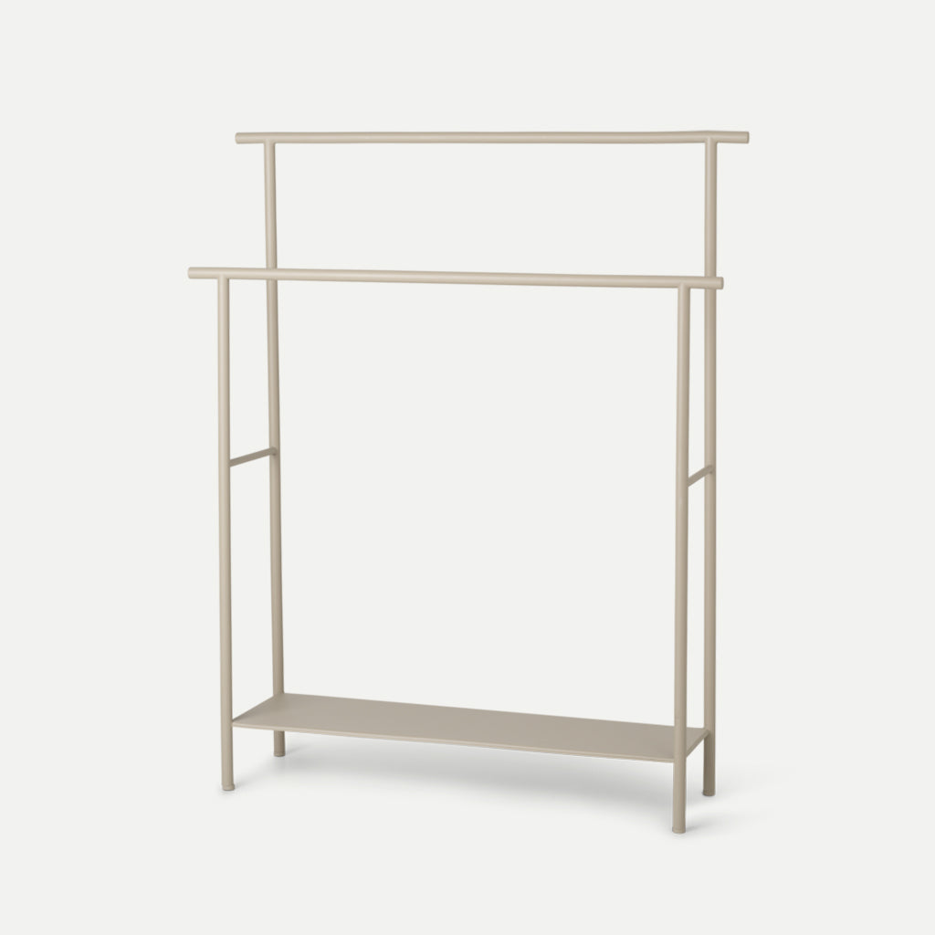 A white Ferm Living Dora Towel Stand with a shelf underneath it.