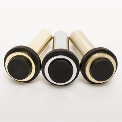 Three Baccman Berglund Dot Door Stops with black and white knobs on a white surface.