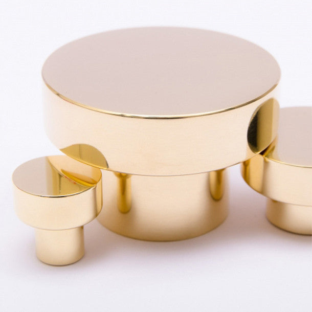 A set of three Dot Knob round tables from Baccman Berglund sitting on top of each other.