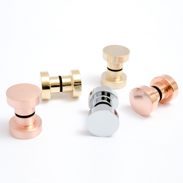 A set of four Dot Shower Door Knobs with different finishes by Baccman Berglund.