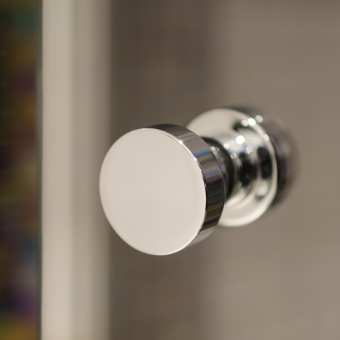 A close up of a Baccman Berglund Dot Shower Door Knob.