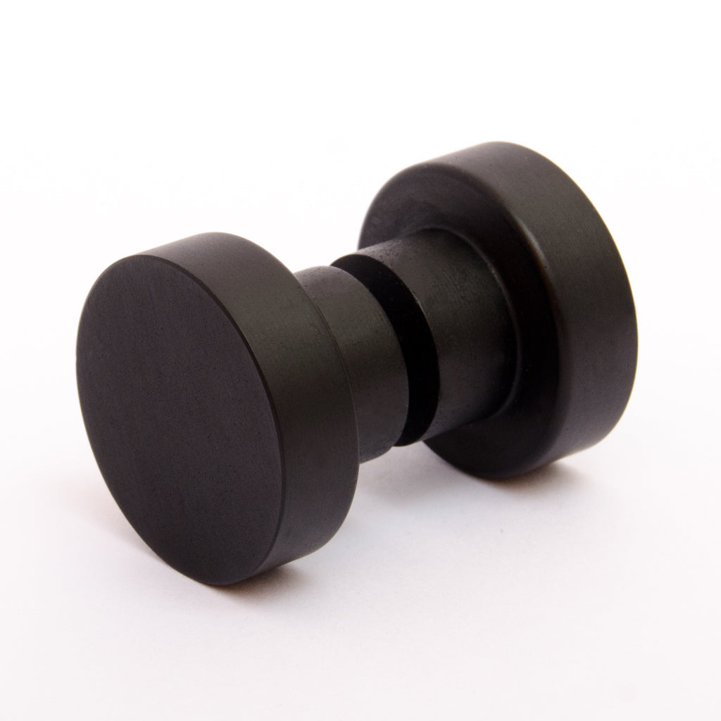 A pair of Baccman Berglund Dot Shower Door Knobs on a white background.