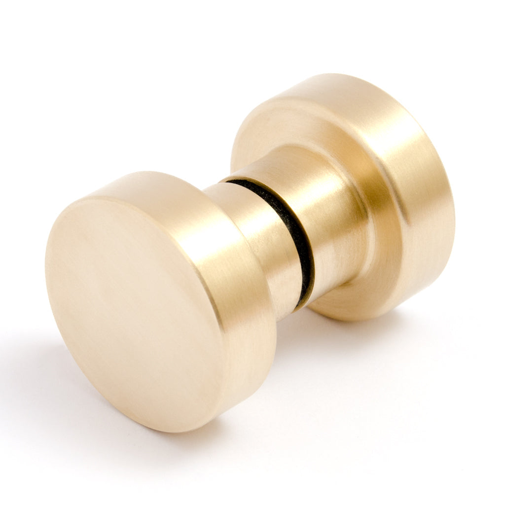 A close up of a Baccman Berglund Dot Shower Door Knob on a white background.