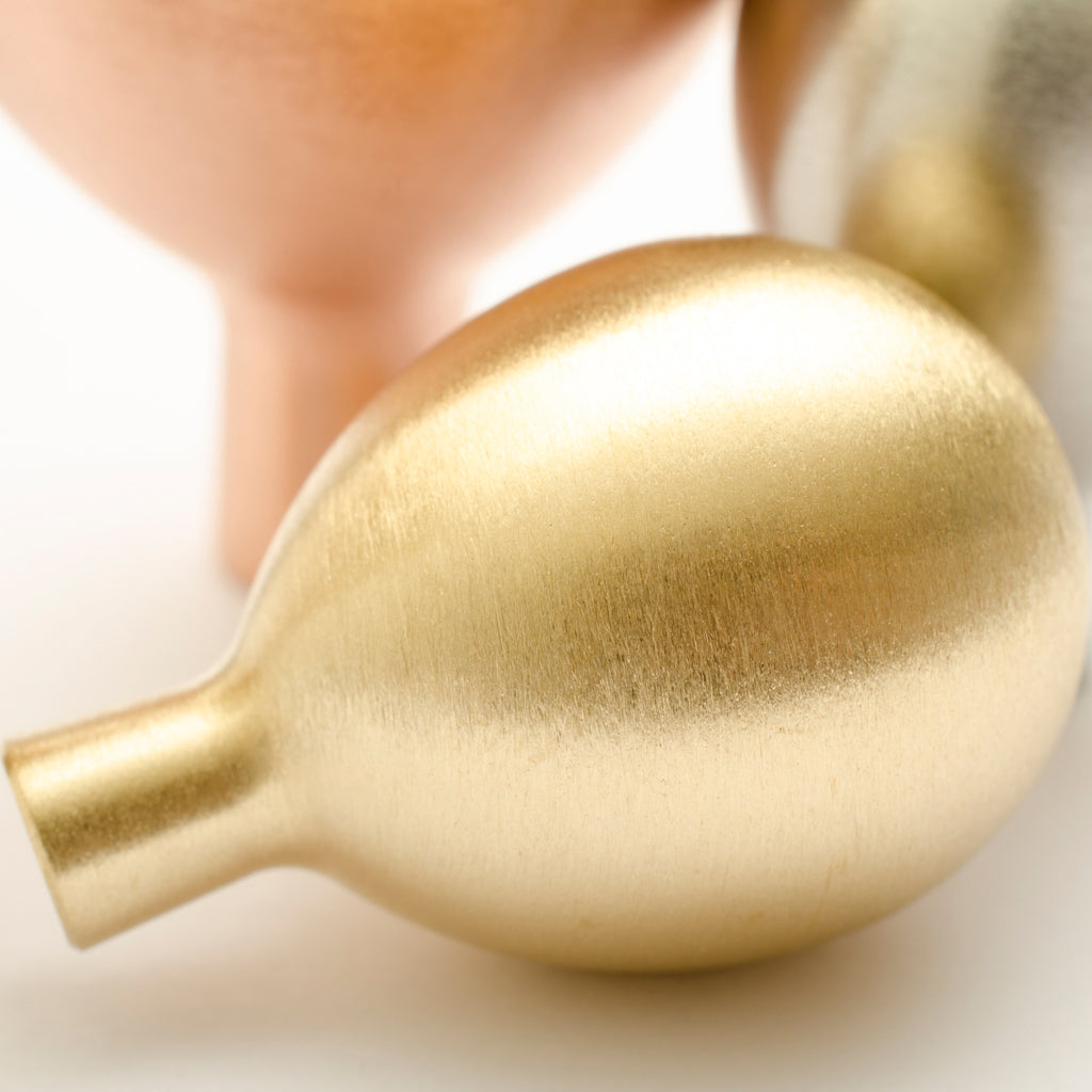 A close up of a Baccman Berglund Drop Knob on a white surface.