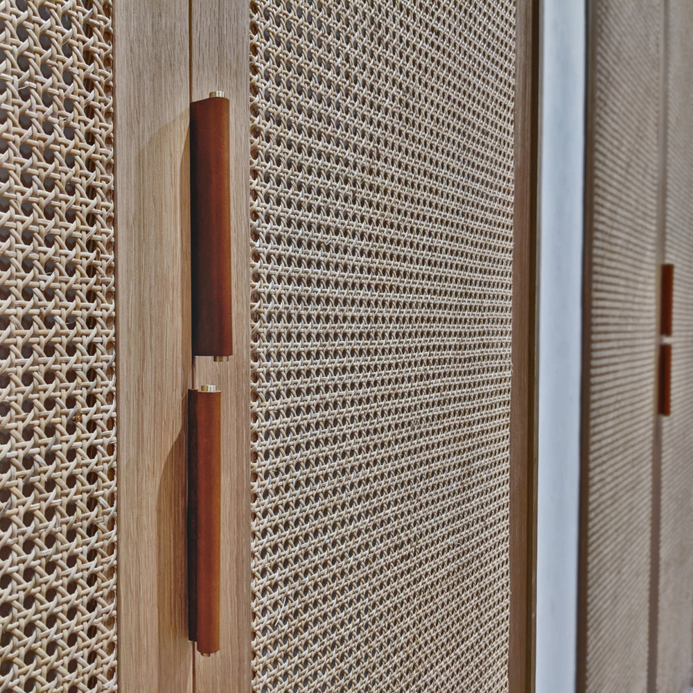 Brown Leather Tab Pulls on cane cabinet door 