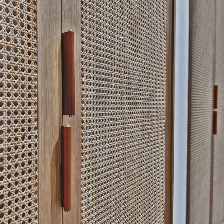 Brown Leather Tab Pulls on cane cabinet door 