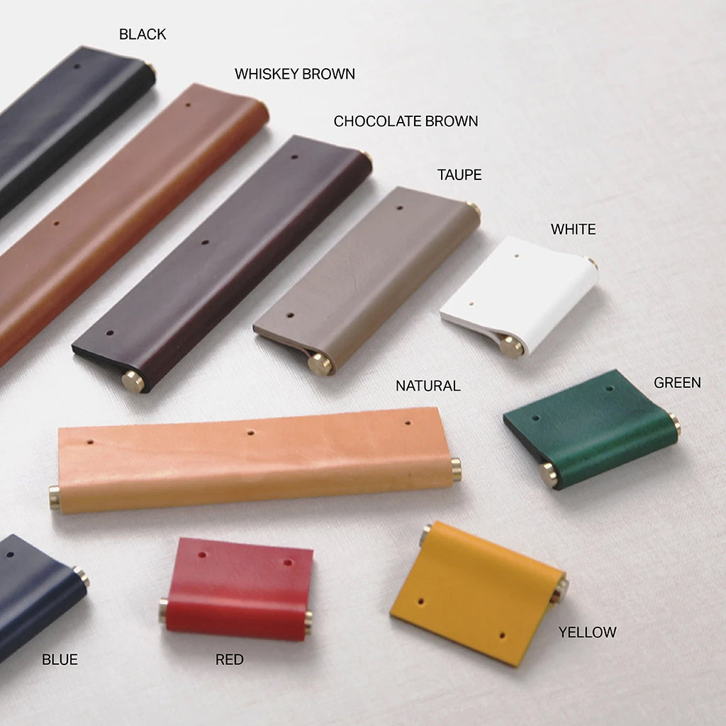 A group of EP01 Leather Edge Pulls: Satin Brass Core by Chapman & Bose in different colors of wood and metal.