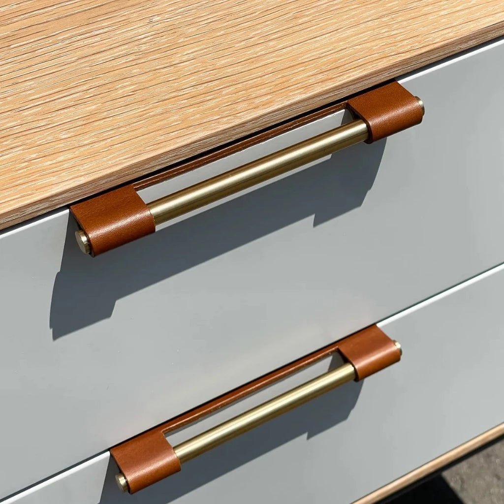 Tan leather Chapman & Bose EP03 edge pull on a drawer.