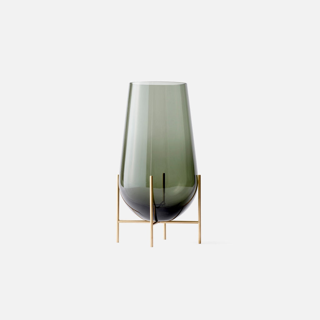 Medium smoked glass vase sitting on beautiful bronze legs.