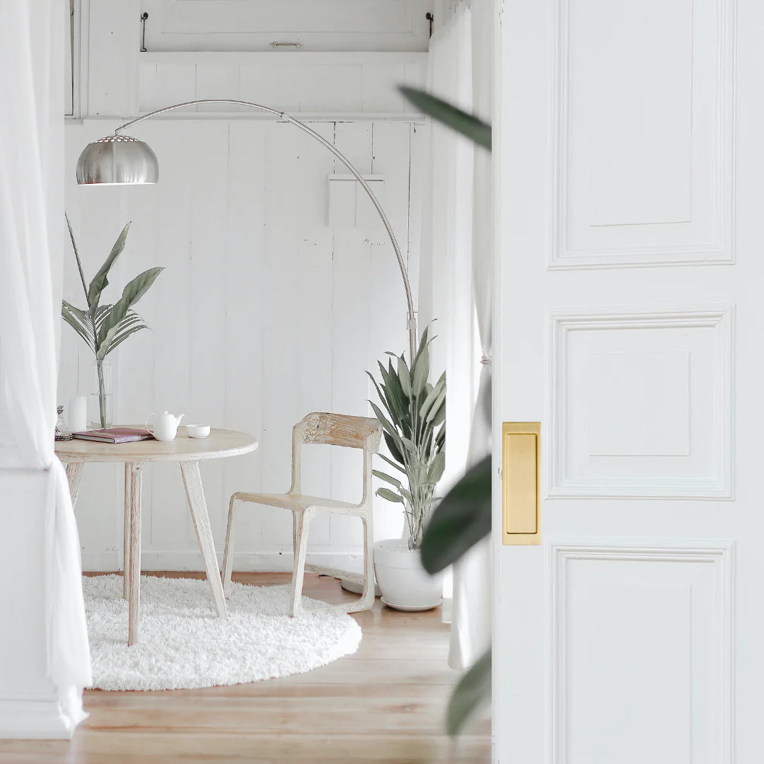 A white room with an AHI Explore Pocket Door Set Passage and two AHI chairs.