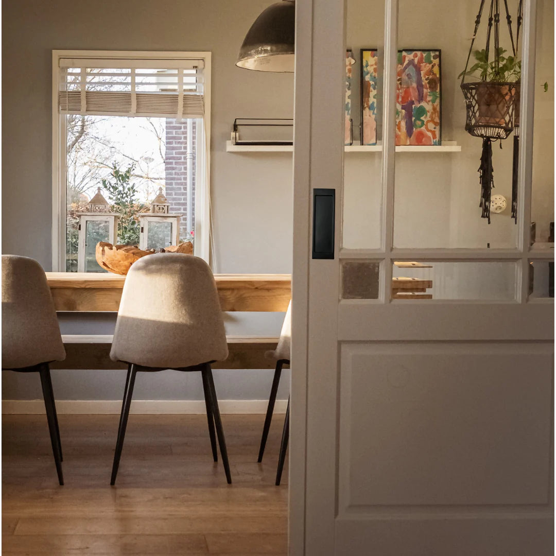 A dining room with an AHI Explore Pocket Door Set Passage table and chairs.