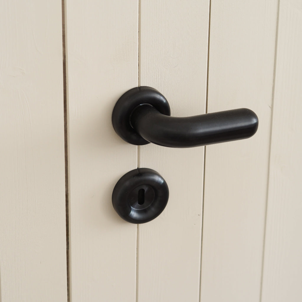 PVD black d line FAT door lever with a round escutcheon on a panelled door.