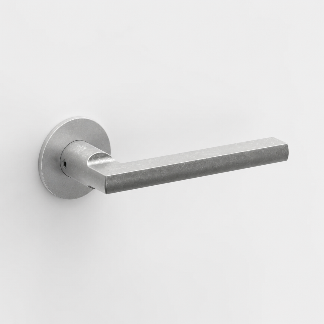 FSB 1035 matte silver door lever with a flat, ergonomic design and circular rose on a clean white background.