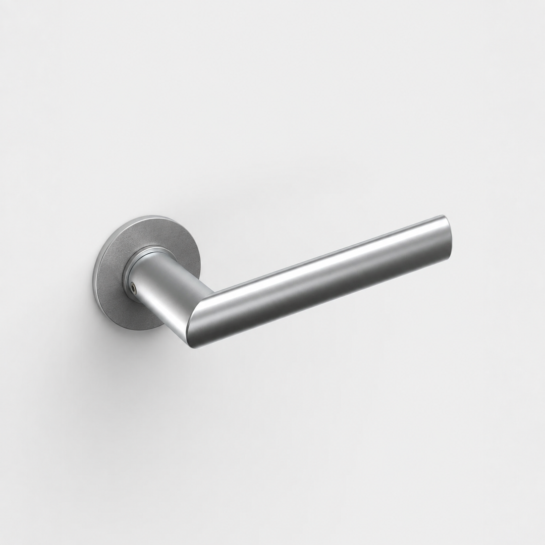 FSB 1108 stainless steel door lever with a round neck and ergonomic mitred grip on a circular rose against a white wall.