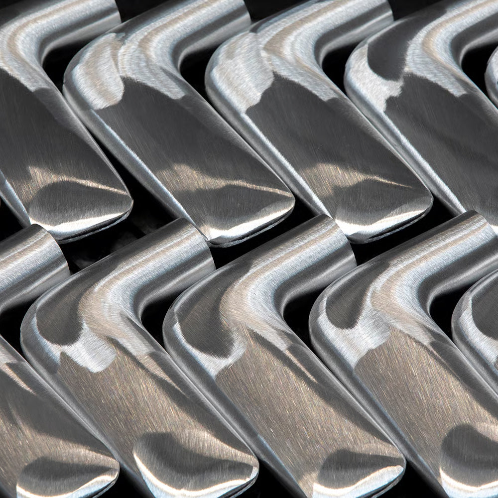 A row of polished FSB 1291 levers repeating in close-up, showing the soft geometry of the form.