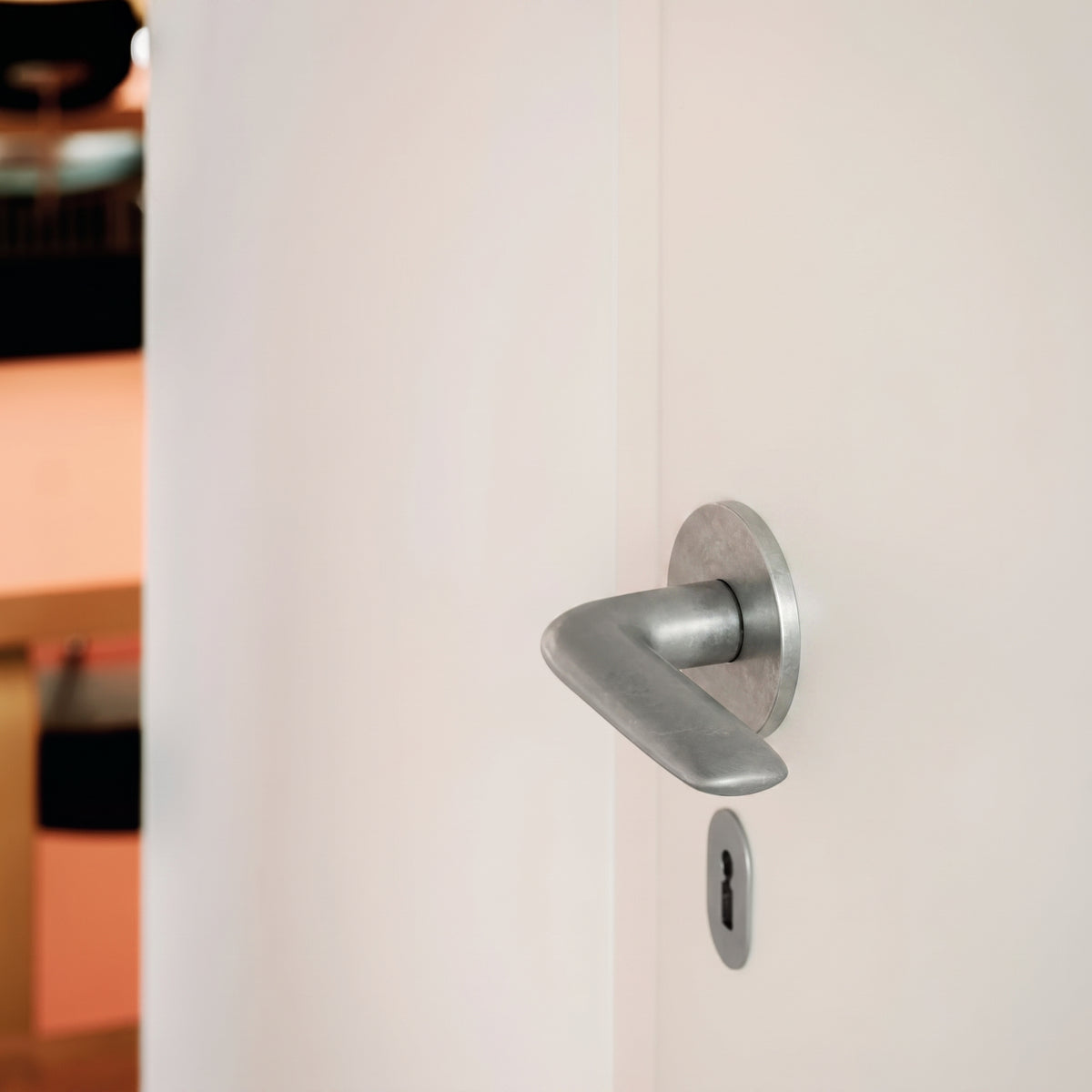 Sleek matte silver FSB 1292 door lever with a circular rose mounted on a clean white interior door.