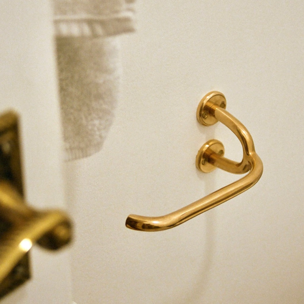 Brass Maha Alavi Fauna toilet paper holder, an organic cast bracket.