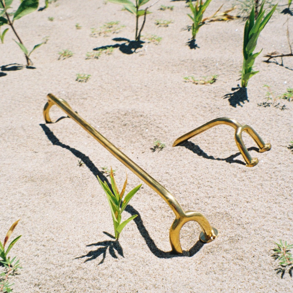 Brass Maha Alavi Fauna hardware styled on sand.
