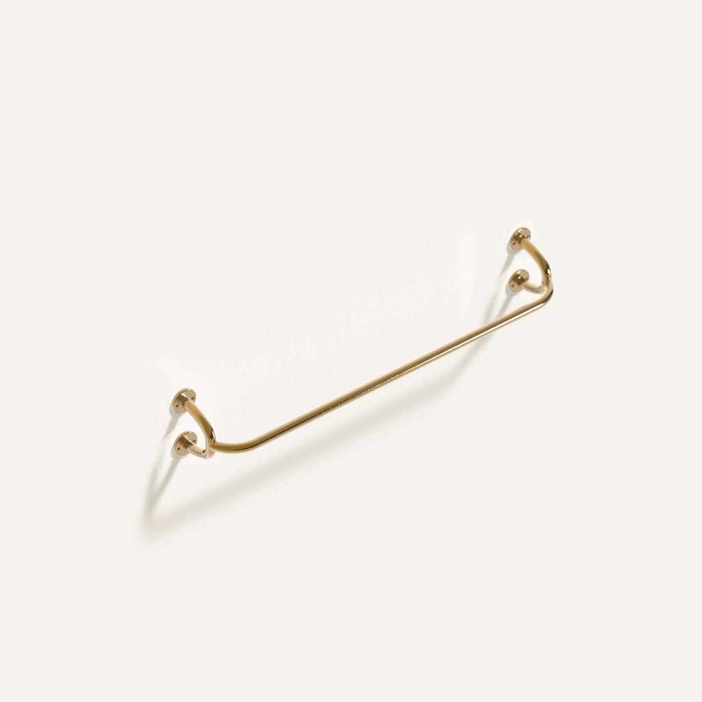 Brass Maha Alavi Fauna towel bar, a cast bar with sculptural end brackets.