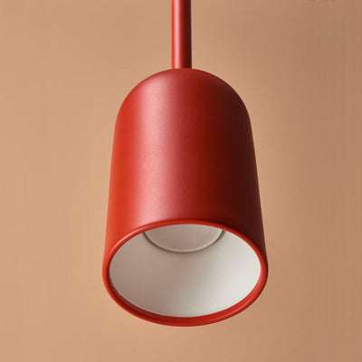 A Schneid Figura Pendant Arc lamp hanging from a ceiling in a room.