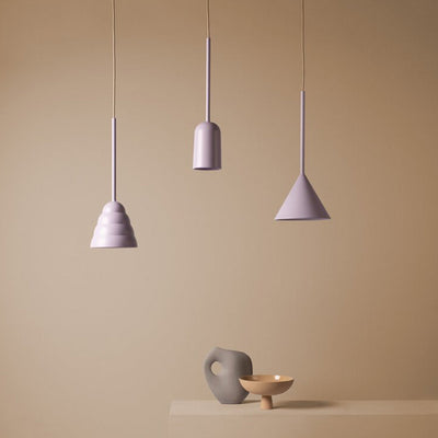 A Schneid Figura Pendant Cone with some lights hanging from it.