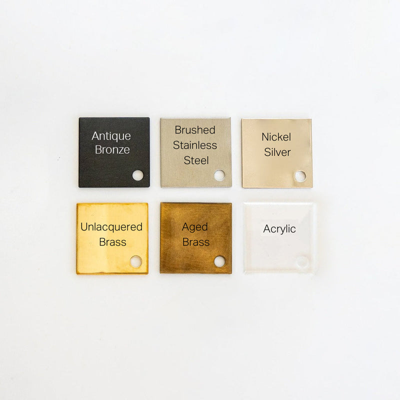 Forbes & Lomax finish sample tiles in antique bronze, brushed stainless steel, nickel silver, unlacquered brass, aged brass and acrylic.