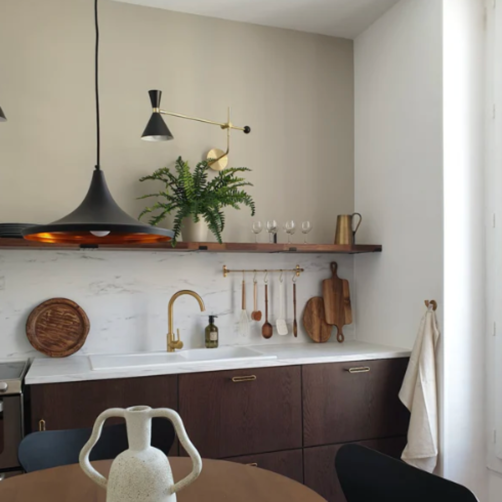 a kitchen with a Mi & Gei Forme No. 1 Hanging Rail and wooden table and black chairs.