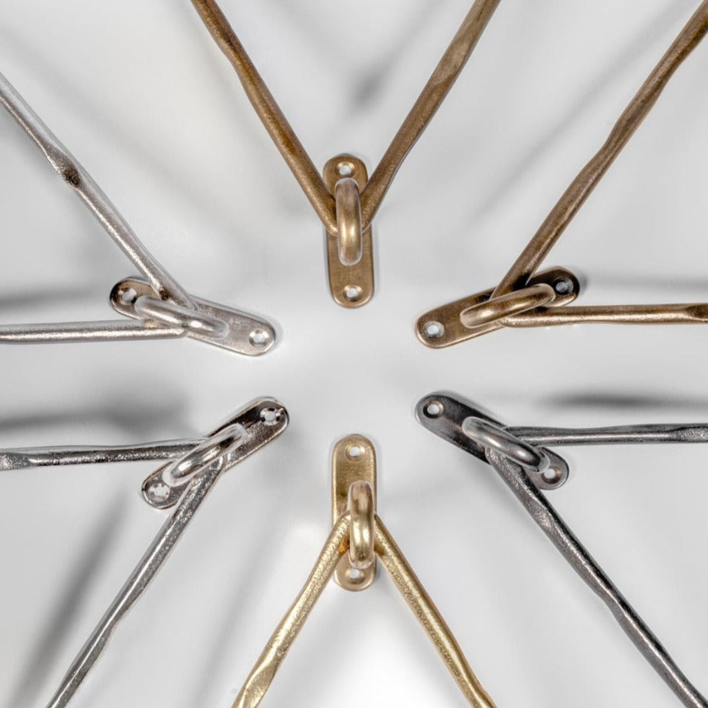 Mi & Gei Forme No. 14 Triangle Towel Rings in a circle on a white surface.