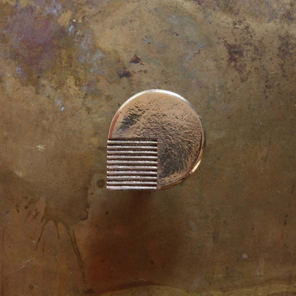 A close up of the Mi & Gei Libre Forme No. 6 Hook on a wall.