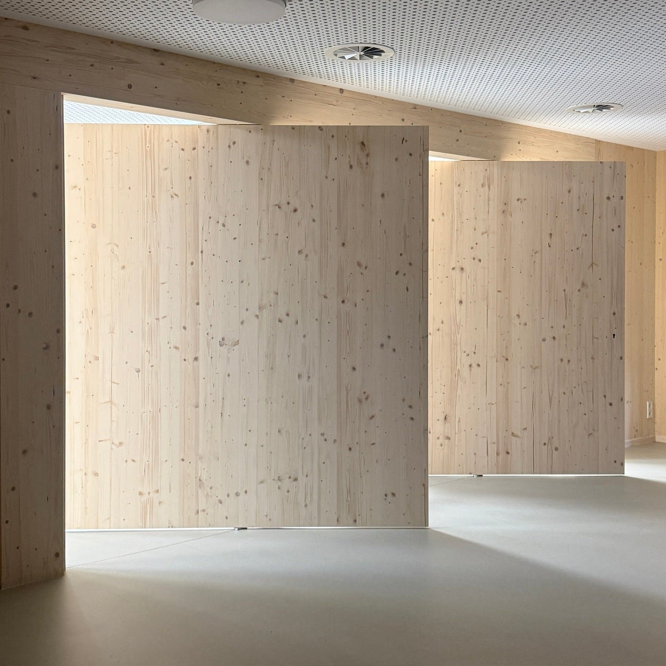 Modern interior with wooden walls and a light floor.