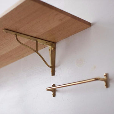 Brass shelf bracket and towel bar. Designed by Oji Masanori.