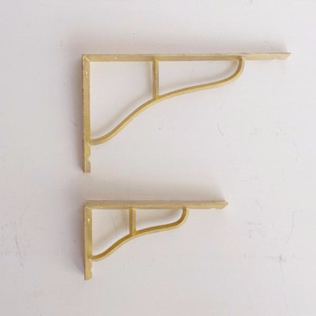 Simple and elegant shelf brackets made from cast brass. Designed by Oji Masanori.