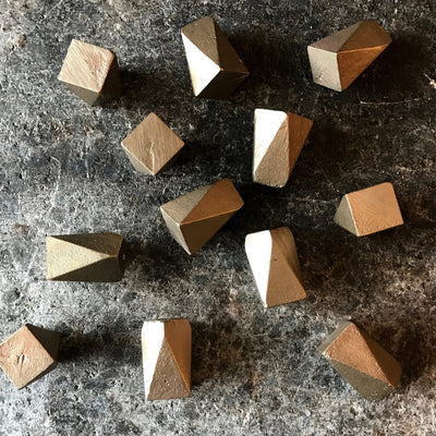 A group of Shayne Fox Geo Knobs/Hooks sitting on top of a counter.