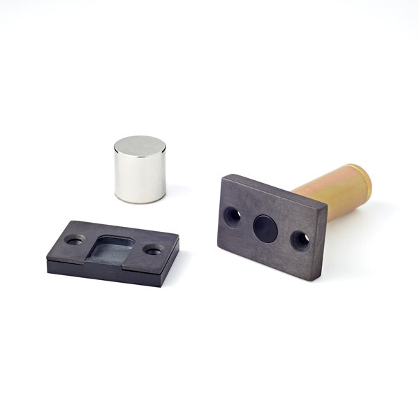 A couple of Ghostop Concealed Door Stops GS200 sitting next to each other.