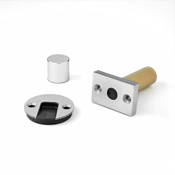 A couple of Ghostop Concealed Door Stops GS300 sitting on top of a white surface.