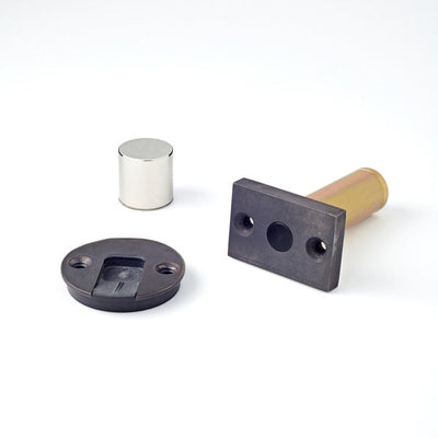 A couple of different types of Ghostop Concealed Door Stops GS300 on a white surface.