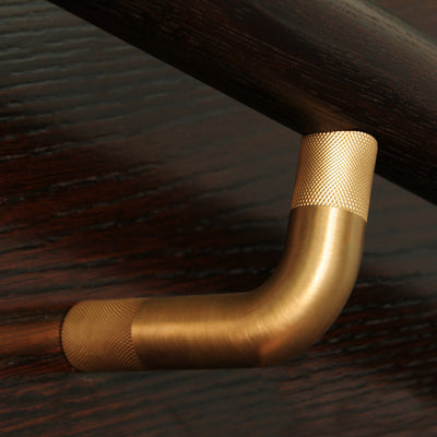 A close up of a Halliday Baillie HB 580 Handrail Bracket on a wooden surface.