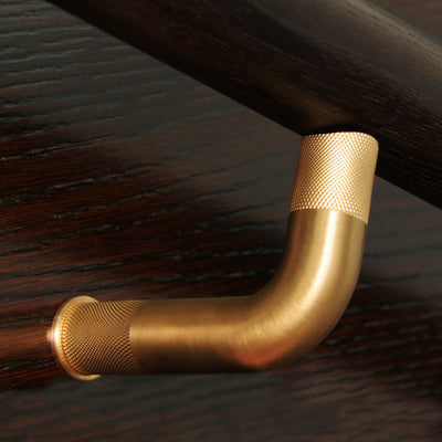 A close up of a Halliday Baillie HB 580 Handrail Bracket on a wooden surface.