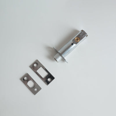 A couple of Baton Heavy Duty Mortise Bolt LT783MB/LT786MB metal parts sitting on top of a white table.