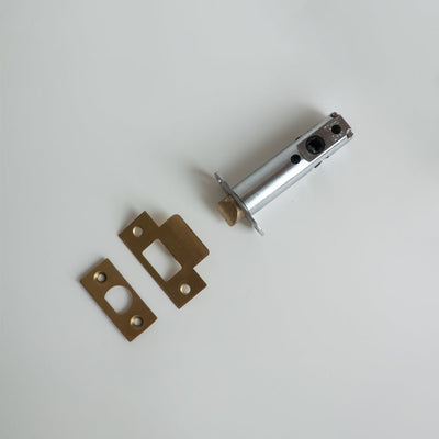 A couple of Baton Heavy Duty Passage Latch LT843 / LT846 pieces of metal sitting on top of a table.