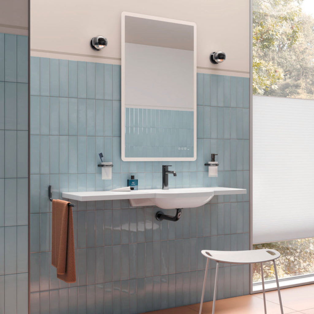 Matte black Hewi 480 grab rail on a blue tiled wall.