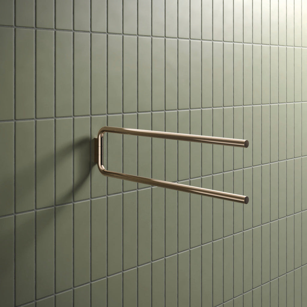 Bronze Hewi 480 towel rail, an open U-shape on a green tiled wall.