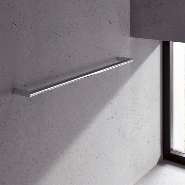Metal towel bar on a textured gray wall