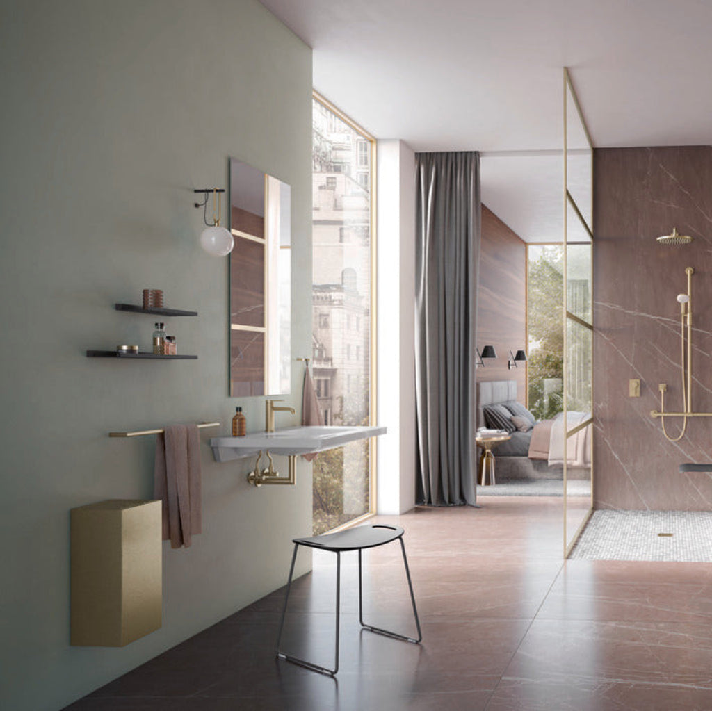 Modern bathroom interior featuring a wall-mounted sink, brass fixtures, open shelving, and a walk-in shower with gold accents.