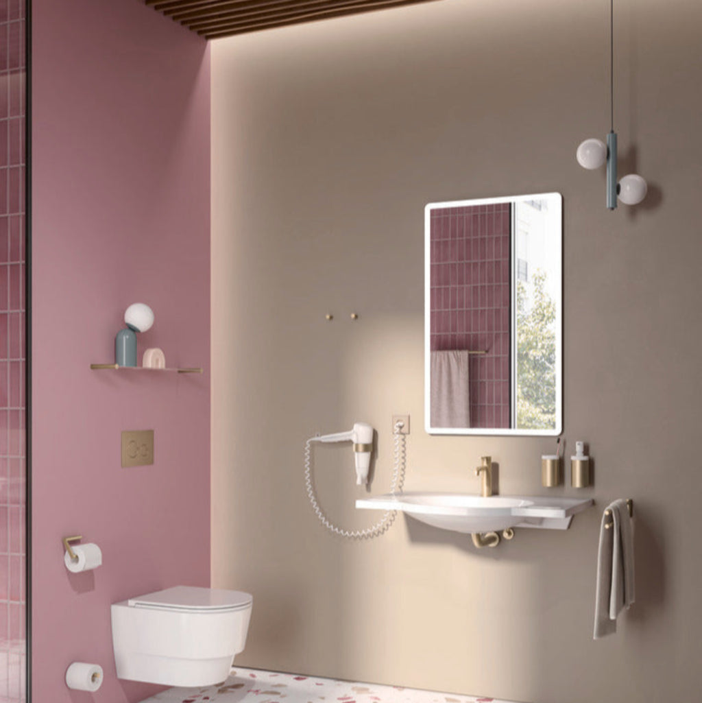 A pink and beige bathroom with Hewi fittings.