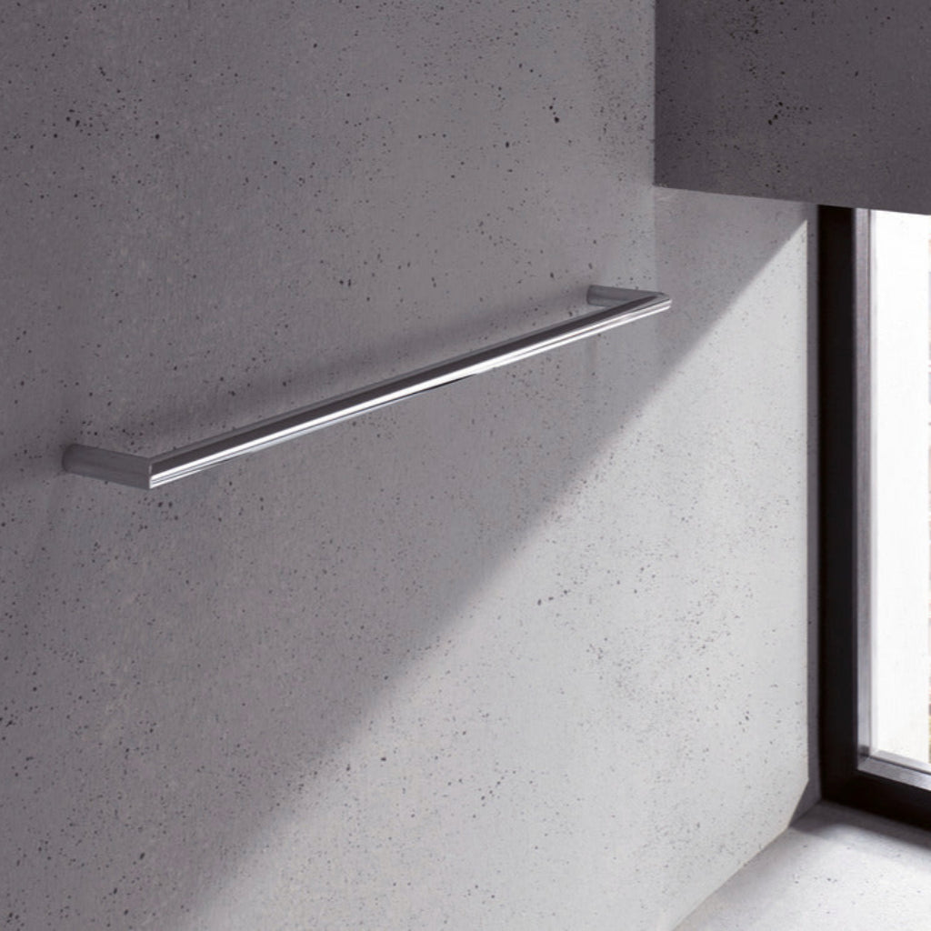 Metal towel bar on a textured gray wall